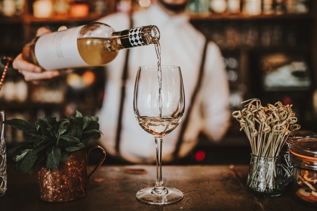 White wine being poured in a wine glass