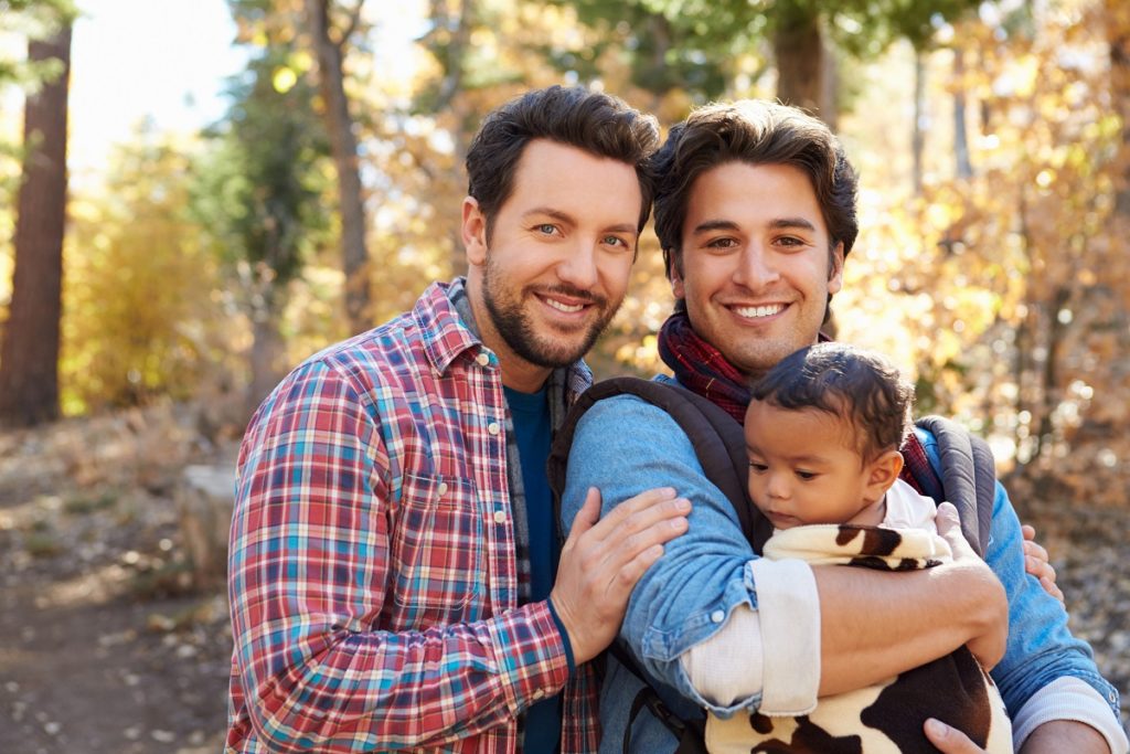 gay couple with their adoptive child