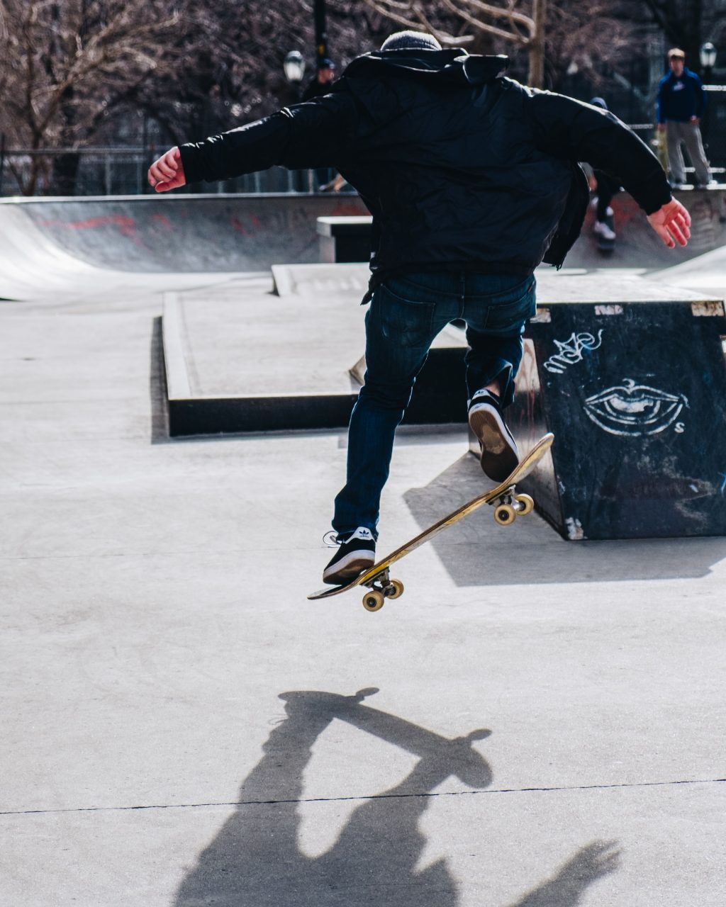 skater doing trick in black hoodie